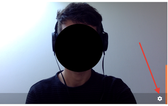 The camera preview with an arrow pointing to the gear icon for device settings at the bottom right